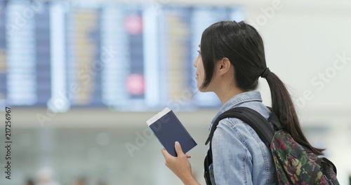 Canvas Print Woman holding passport in the airport