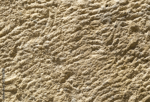 The texture of the limestone slab with small scratches and holes