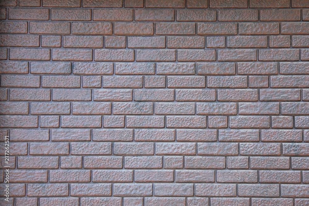 Grey brick wall background and texture in bright day.