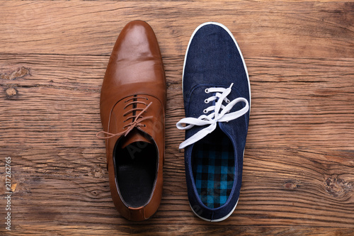 Elevated View Of Two Different Shoe