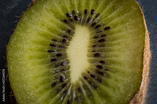 Cut kiwi close-up on a dark background. Closeup