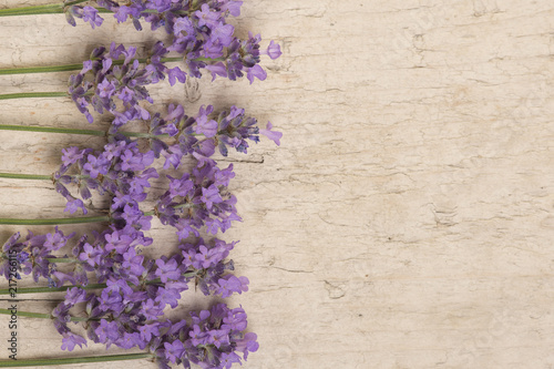 Lavender flowers on the left side on a scaffolding wooden background seen from an high angle