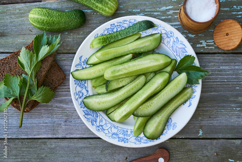Slices of fresh cucumbers with salt on a plate