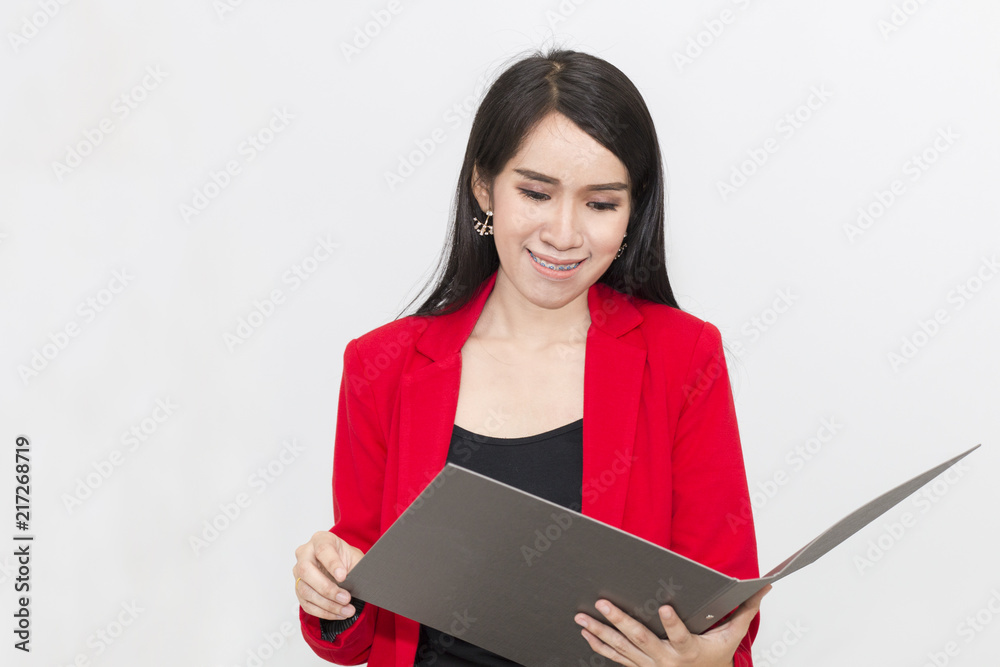Portrait of beautiful 20-30 years.Young businesswoman in red suit holding  document file.She looking smiling and  success in the job.Copy space.