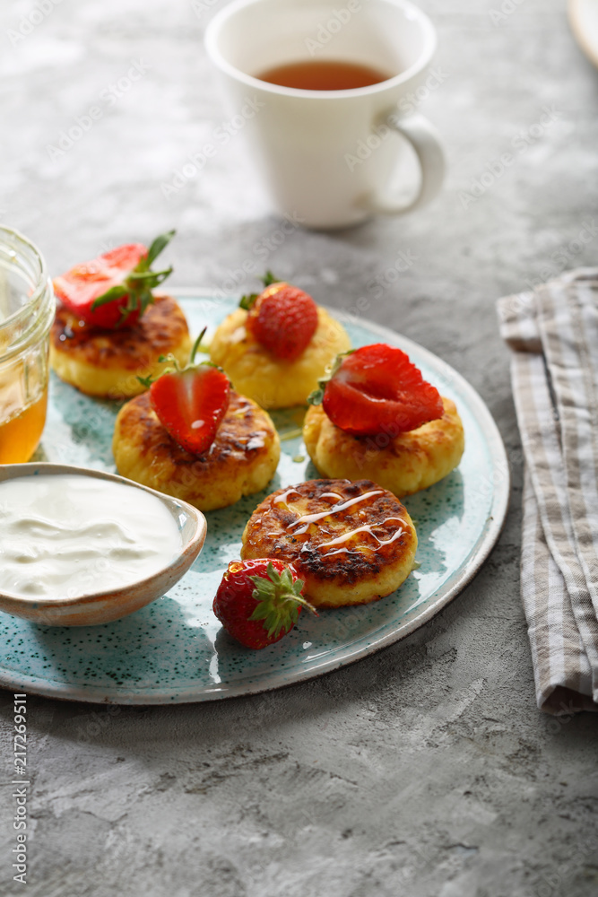 Breakfast pancakes with cream and cup of tea Breakfast pancakes with cream and cup of tea