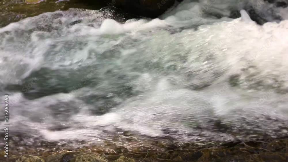 Rushing creekwater close-up. Rushing creekwater close-up.