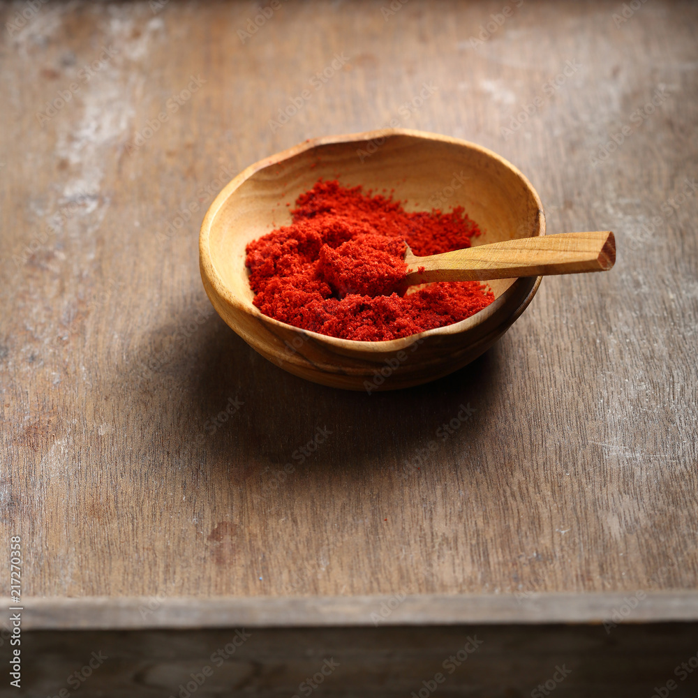Flavor red paprika powder in bowl Flavor red paprika powder in bowl