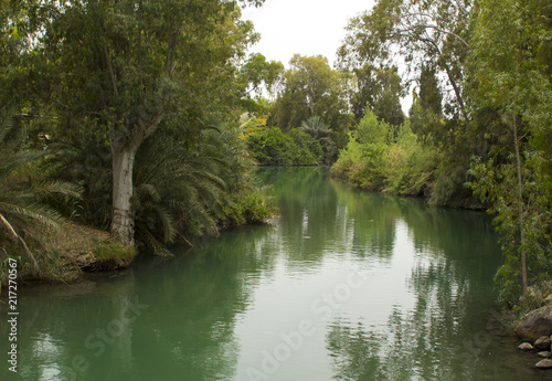 The calm running River Jordan at the Yardenit Baptismal Site the traditional place of John the Baptist and his ministry 