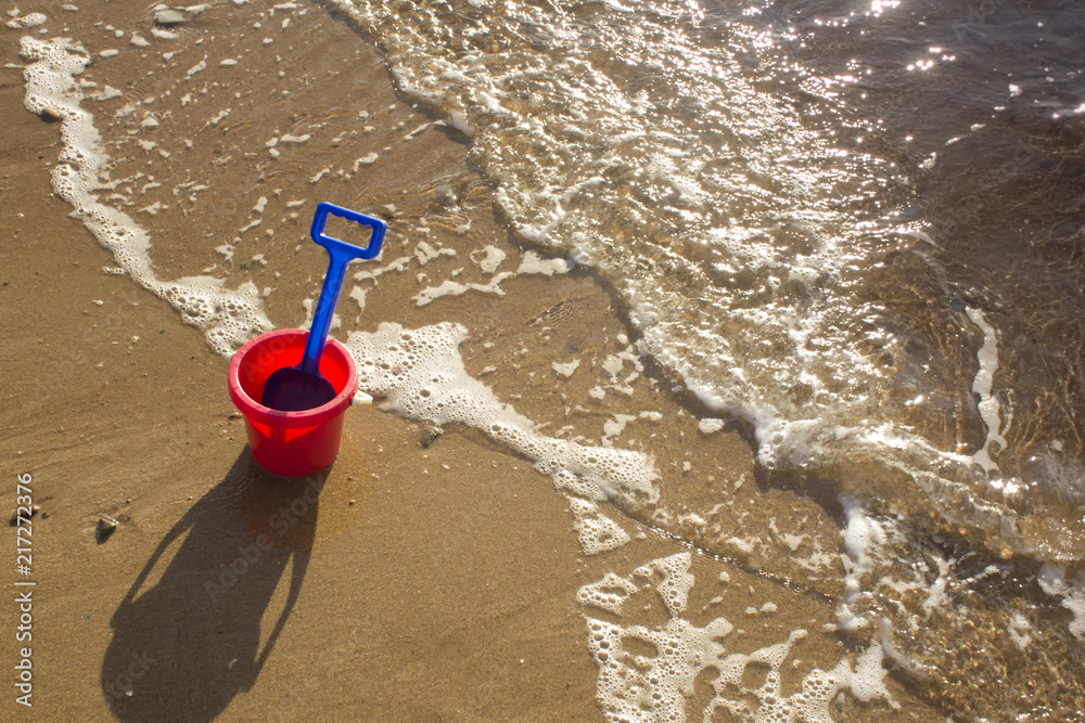 Bucket and shovel on a sandy beach
