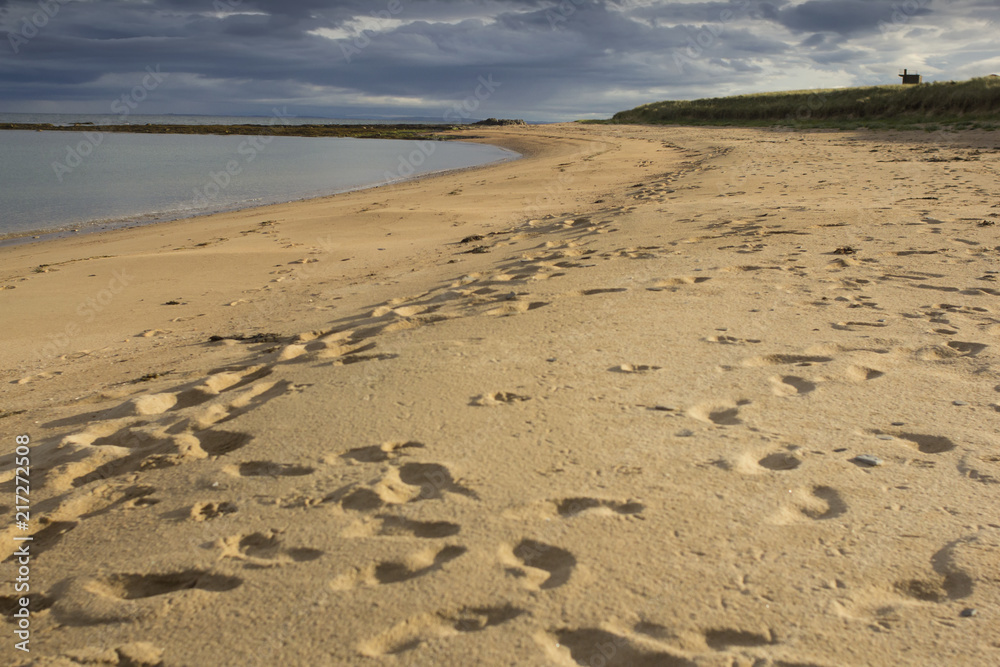 Footprints in the sand on a Scottish beach  