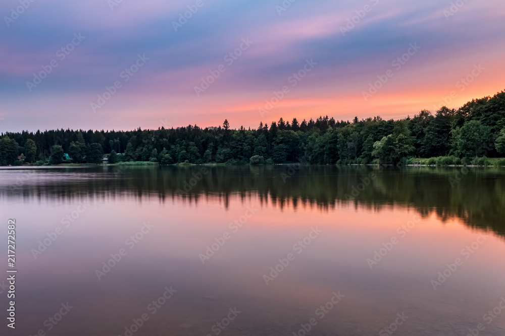 Pond at amazing sunset in summer landscape