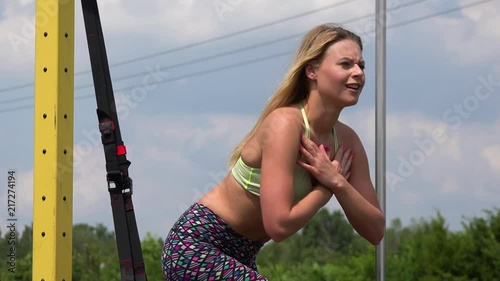 A beautiful fit woman does bulgarian squats at an outdoor gym - closeup