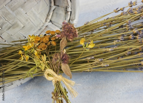 Fototapeta Naklejka Na Ścianę i Meble -  The bouquet of dry lavender on the pale blue background, floral arrangement