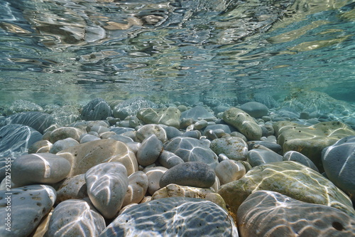 Underwater pebbles and rocks below water surface on the seashore, Mediterranean sea, Costa Blanca, Javea, Alicante, Valencia, Spain