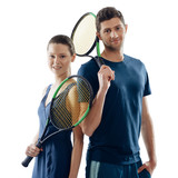 Portrait of tennis players, isolated on white. Young man and woman holding a racquets, giving a slight smile.