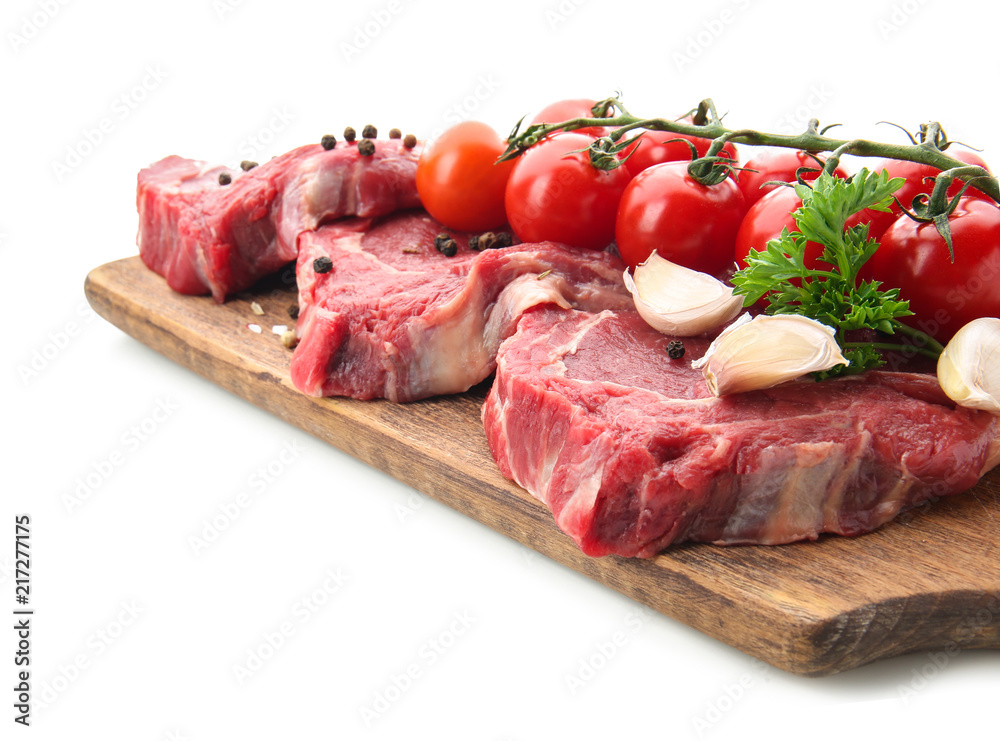 Fresh raw meat with spices and vegetables on white background Fresh raw meat with spices and vegetables on white background