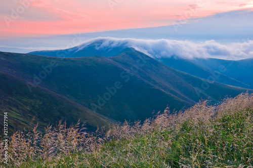 The cloud of morning fog above the top of the mountain. Summer mountain landscape. Carpathians, Ukraine, a mountain range Borzhava. © physyk