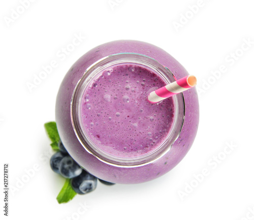 Glass jar of tasty blueberry smoothie on white background, top view
