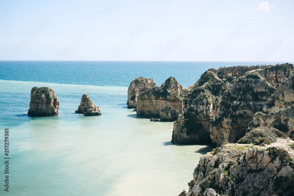 Fototapeta premium Beautiful views of the Atlantic Ocean and the rocks off the coast of Portugal next to the city called Lagos. Amazing natural landscape.
