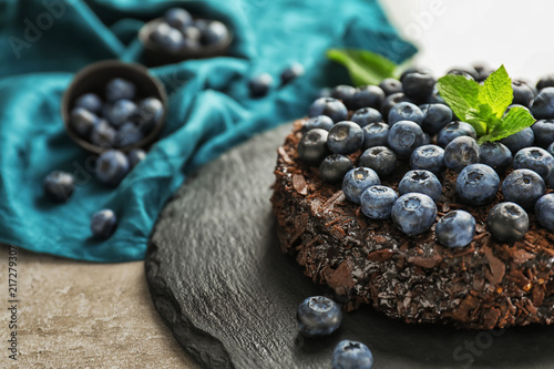 Delicious blueberry chocolate cake on slate plate