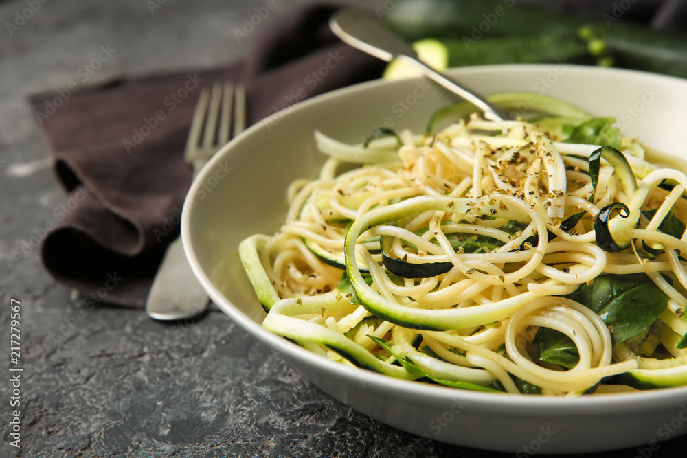 Plate of spaghetti with zucchini on table, closeup Plate of spaghetti with zucchini on table, closeup