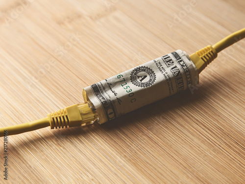 Slika na platnu The cost of internet data plans in America concept image consisting of a dollar(USA) note and Ethernet cable