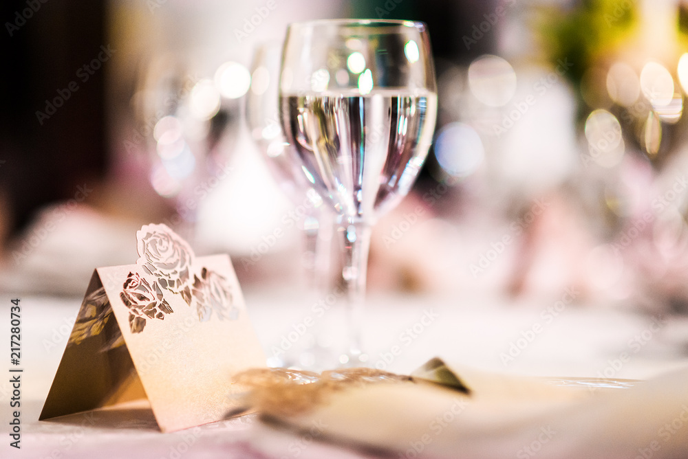 Fototapeta premium Wedding table with a place card and glasses