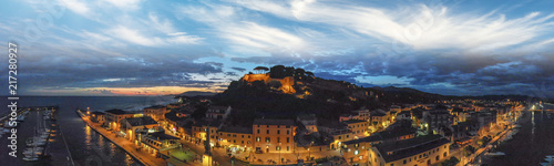 Panoramic aerial night view of Castiglione della Pescaia after sunset