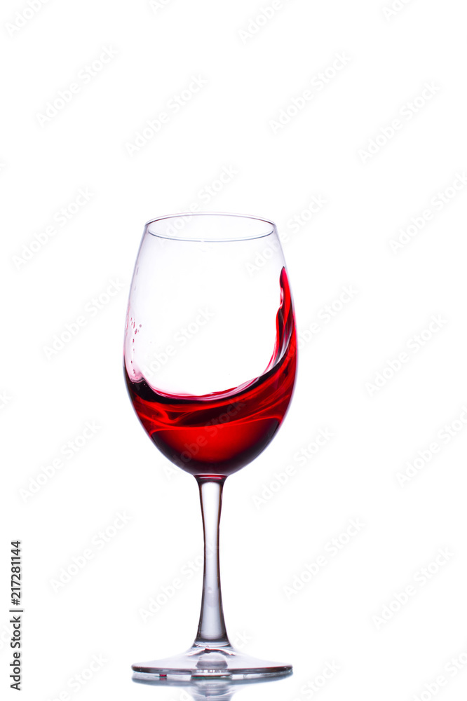 A splash of wine in a glass. A splash of red wine. A glass with red wine on a white background. A splash of wine in a glass. A splash of red wine. A glass with red wine on a white background.