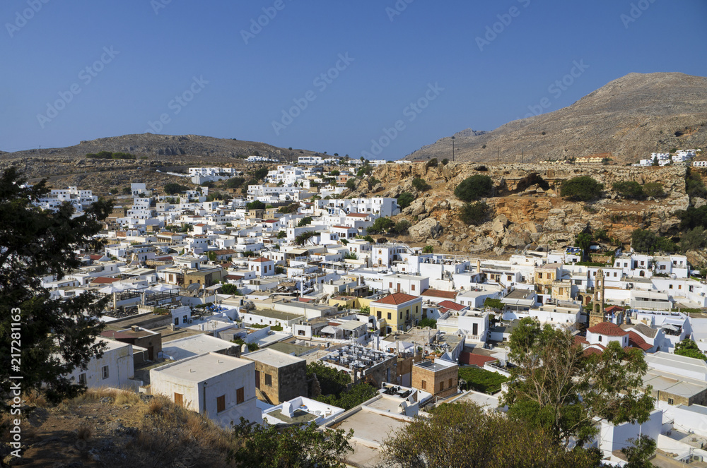 Beautiful panoramic view of Lindos with white roofs and blue sky (Rhodes, Greece)