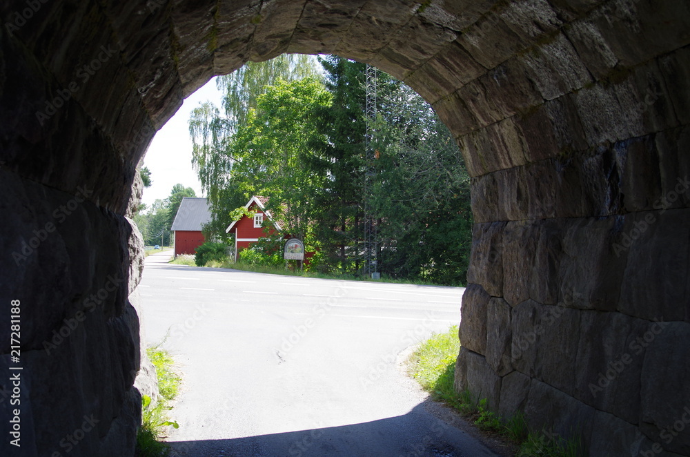 A stone tunnel with an arch in rural Dalarna