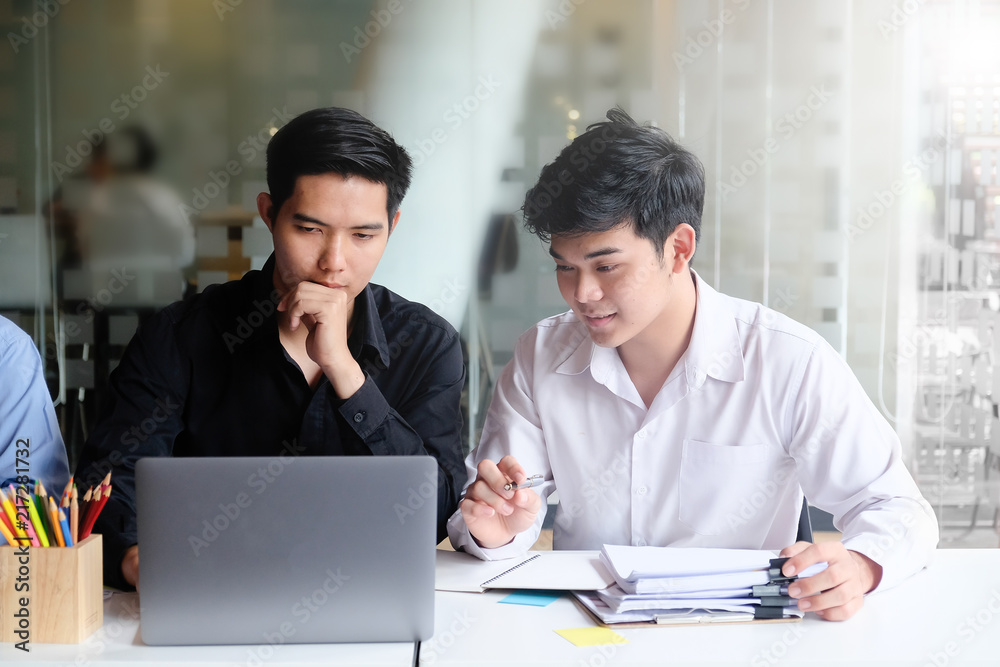 Young businessman meeting and brainstorming with laptop computer on office workplace. Young businessman meeting and brainstorming with laptop computer on office workplace.