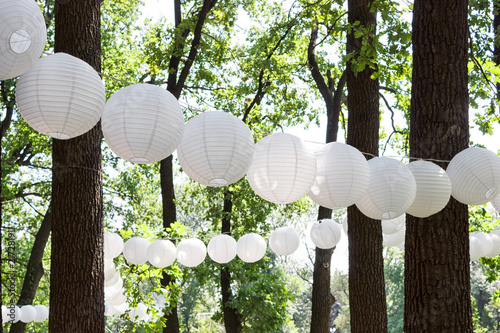 Paper lanterns in the park in the trees. Sunny. Summer
