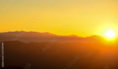 sunset in the mountains, backlight, the sun hides behind the mountains, an observation deck, the rays of the sun, the end of the day