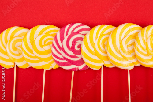 Bright candy on a red background. Lollipops. Handmade.