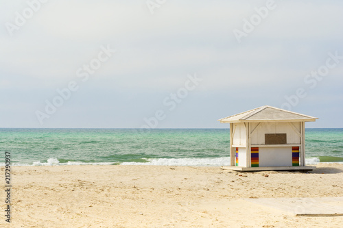 Ocean background. Empty beach. White beach huts next to the sea. © alexytrener