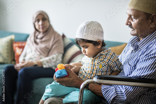 Muslim family relaxing and playing at home photo