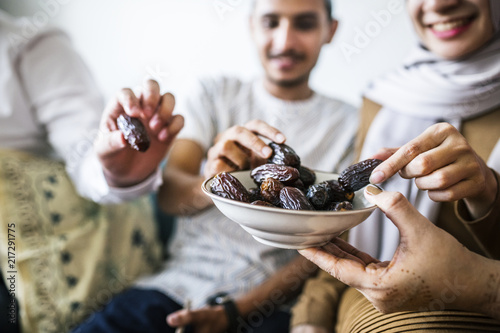 Muslim family having dried dates as a snack photo