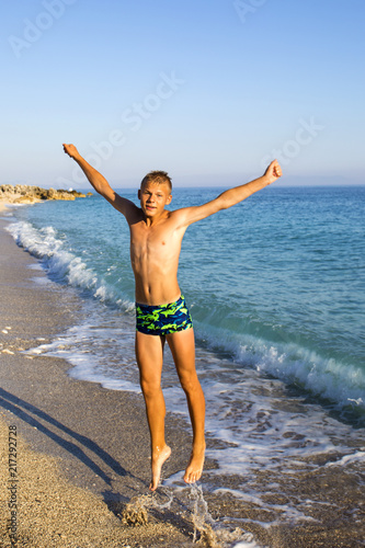 teenager jumping on the seashore.joy. fun. emotions.Summer vacation,