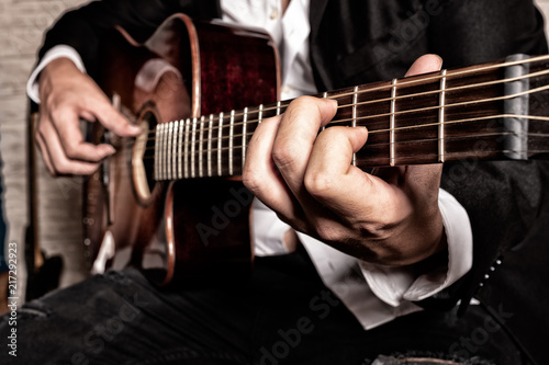  hands of musician playing the guitar