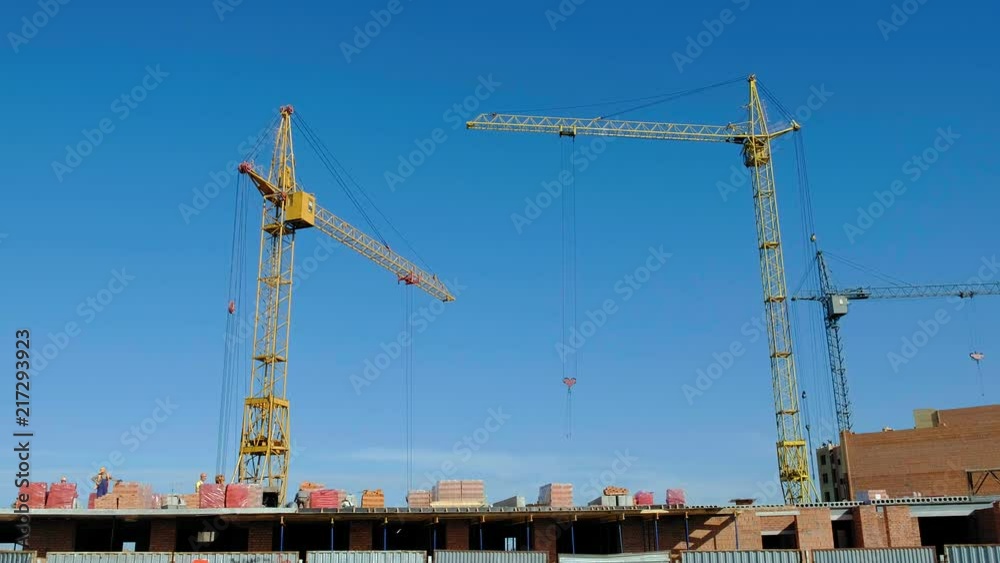 Building construction, work of people and crane Building construction, work of people and crane