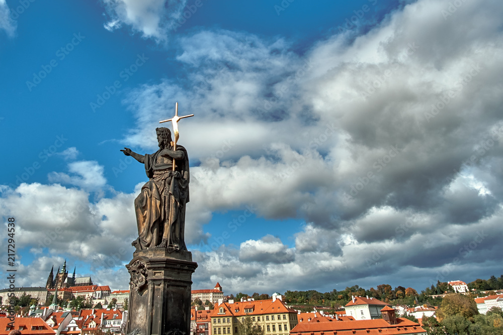 Statue of John the Baptist on the Charles Bridge with Prague Castle