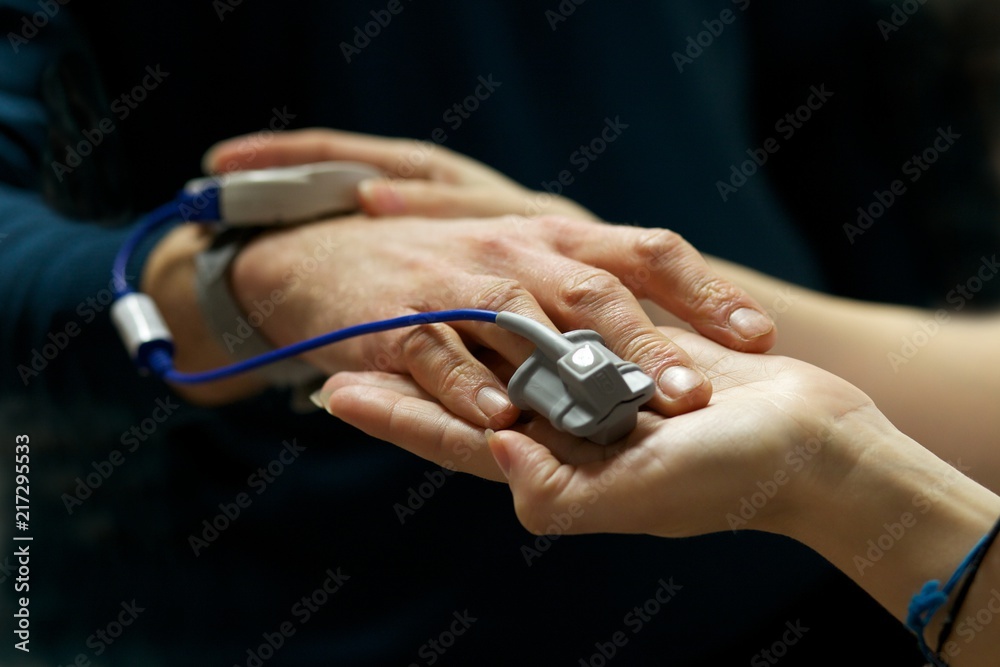 Close up of nurse a patients pulse using a pulse oximeter