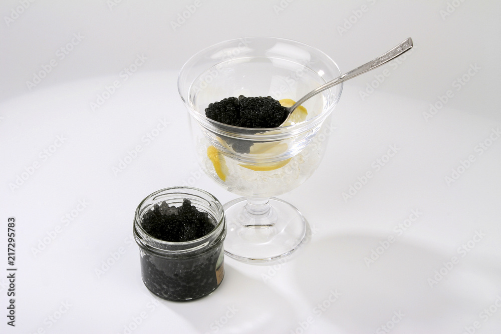 Caviar with spoon and lemon isolated on white Caviar with spoon and lemon isolated on white