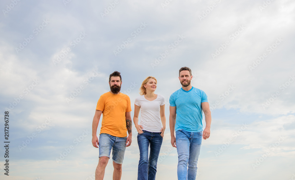 Friendship tested for years. Having proper people near feels like supernatural energy. Men and woman walks dramatic cloudy sky background. United threesome true friends. Friends since childhood Friendship tested for years. Having proper people near feels like supernatural energy. Men and woman walks dramatic cloudy sky background. United threesome true friends. Friends since childhood