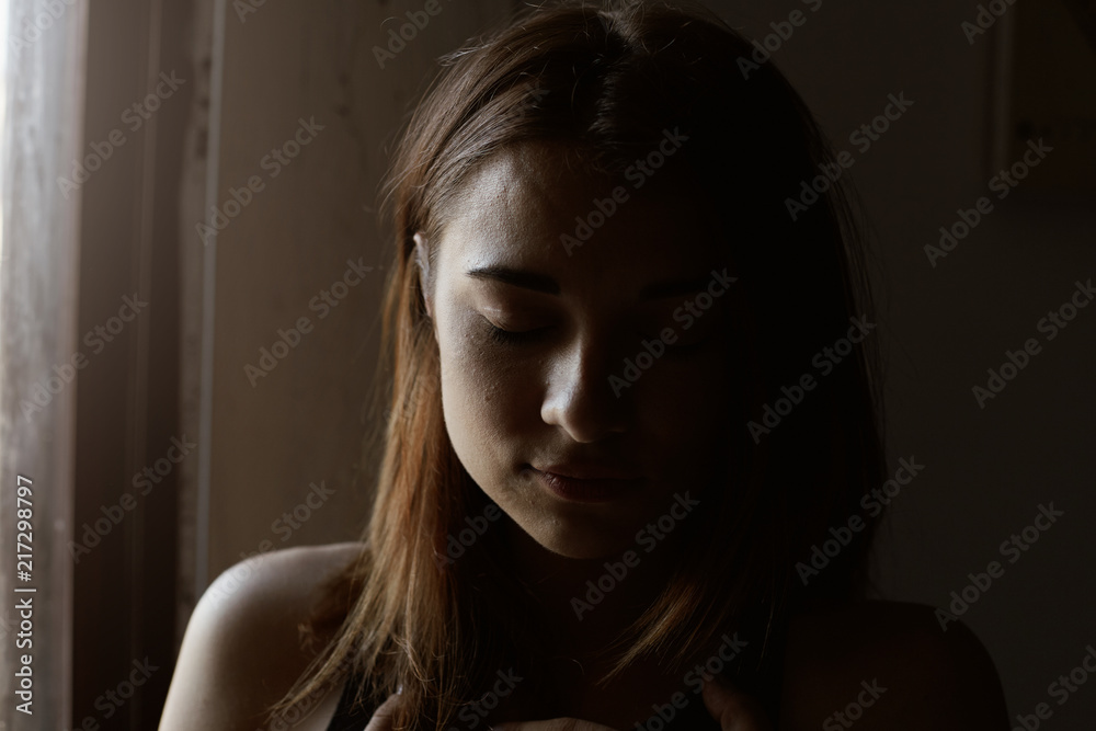 Authentic natural close up portrait of mixed raced woman, closing eyes from pleasure, posing indoors under window light. Candid shot of young attractive female with no make up and no retouch. Authentic natural close up portrait of mixed raced woman, closing eyes from pleasure, posing indoors under window light. Candid shot of young attractive female with no make up and no retouch.