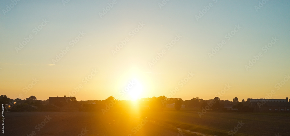 Fototapeta premium Netherlands, South Holland, a sunset over a body of water
