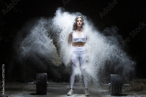 Woman working out with weights in the gym