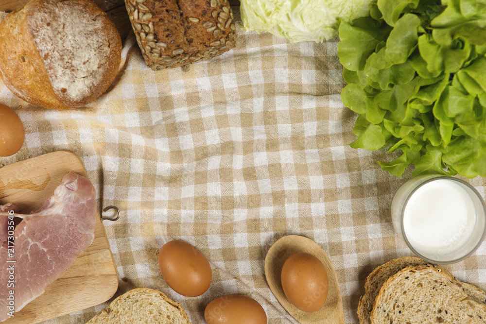 Set products consisting of bread, milk, pork, eggs , and vegetable on wooden table background, fresh food for cooking Set products consisting of bread, milk, pork, eggs , and vegetable on wooden table background, fresh food for cooking