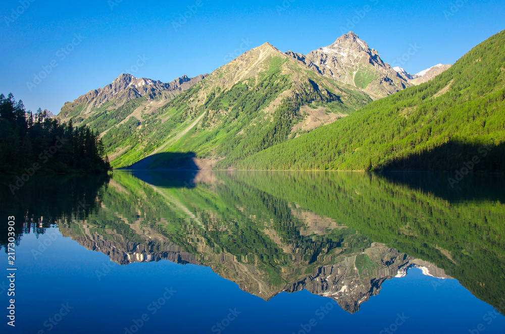 Mirror reflection of mountains in the Kucherlinsky lake, in the Gorny Altai.
